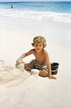 Young Boy building Sandcastles on Beach