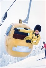 Woman leaning out of Ski Gondola