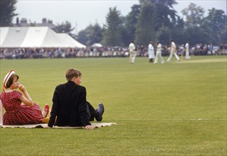 Teen Boy and Girl watching Cricket Match at 'Fourth of June' event
