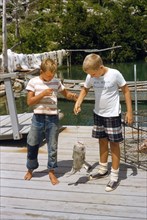 Two Boys with a Caught Fish