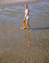 Portrait of Woman in Two-Piece White Bathing Suit on Beach