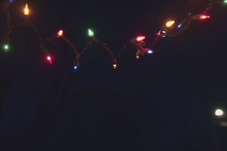 Christmas lights draped along Front Porch at Night