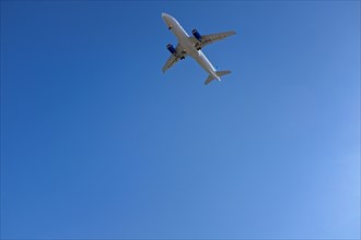 Low Angle View of Commercial Airplane against Blue Sky