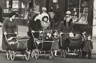 Three Women pushing Baby Strollers across Street