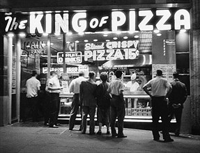 Group of People waiting in Line for Food at Pizza Counter