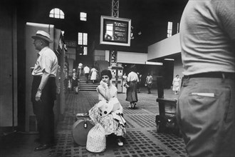 Woman sitting with Luggage