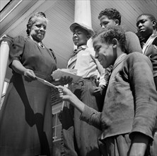 Mrs. Shaw handing out Mail to National Youth Administration