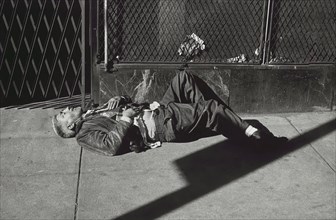 Man Laying on Sidewalk