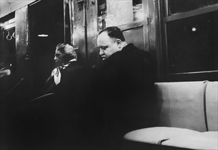 Man and Woman sitting on Subway Seat