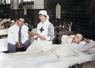 Nurse reading American newspaper to wounded American soldiers in Red Cross Hospital