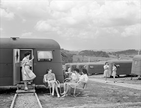 Group of women socializing near trailers used for housing of workers for Tennessee Valley Authority's (TVA) Douglas Dam project