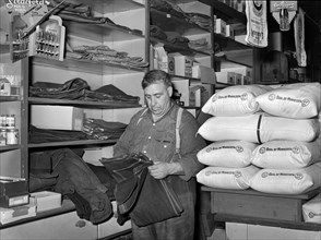 Man shopping for farm clothes in general store
