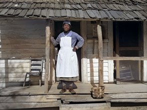Woman in apron on plantation porch