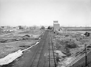 Railroad tracks through rural landscape