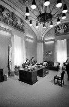U.S. Vice President Richard Nixon seated at his desk in his office in the U.S. Capitol with his press secretary Herbert Klein