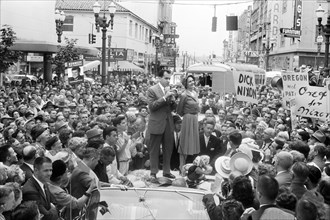 U.S. Vice President Richard M. Nixon with his wife Pat Nixon standing on top of car