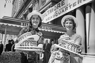 Two women selling hats supporting Senator John F. Kennedy outside Biltmore Hotel during Democratic National Convention