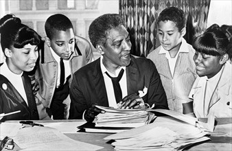 Bayard Rustin (center) speaking with (left to right) Carolyn Carter