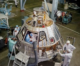 High angle view of mechanics working on aft bay of  Apollo 1 Spacecraft 012 Command Module