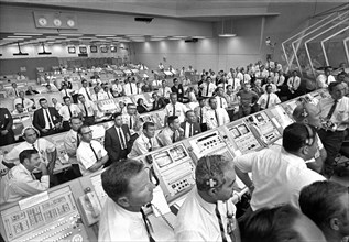 Members of government-industry team rise from their consoles in Launch Control Center to listen to U.S. Vice President Spiro Agnew’s remarks following Apollo 11 liftoff