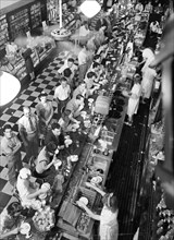 High angle view of lunchtime crowd at noon, People's Drugstore, G Street N.W., Washington, D.C.,