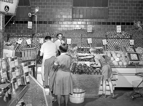Shoppers and workers at fruit counter in supermarket, Giant Food Shopping Center, Wisconsin Avenue,