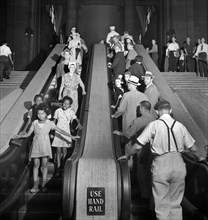 Group of people on escalators, Pennsylvania Station, New York City, New York, USA, Marjory Collins,