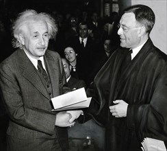 Albert Einstein receiving his certificate of American citizenship from Judge Phillip Forman,