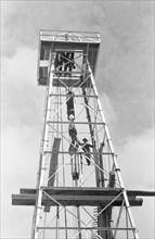 Low angle view of oil worker on oil derrick, Kilgore, Texas, USA, Russell Lee, U.S. Farm Security