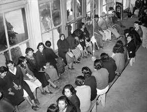 Mexican pecan workers waiting in union hall for assignment to work. San Antonio, Texas, USA,