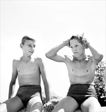 Two young teen boys in swimsuits relaxing after a swim, Rupert, Idaho, USA, Russell Lee, U.S. Farm