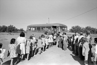 Children of migratory laborers who are living at migratory labor camp boarding school bus, Agua