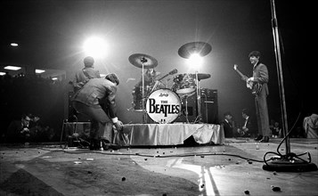 English rock and roll band The Beatles on stage during performance, Washington Coliseum,