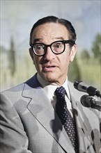 U.S. economist Alan Greenspan, head and shoulders portrait standing at microphones, Washington, D.C