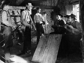 Randolph Scott (center left), Manuel Rojas (center right), on-set of the film, "Buchanan Rides