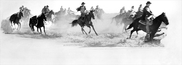 Cowboys on horseback during chase scene, on-set of the film, "Cheyenne", Warner Bros., 1947