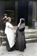 Two Syrian women talking in front of residential building, New York City, New York, USA, Bain News