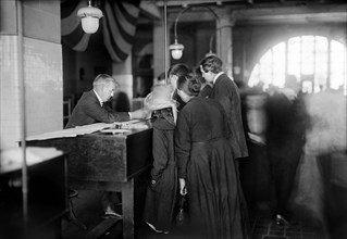 Group of arriving immigrants in examination room, Ellis Island, New York City, New York, USA, Bain