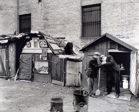 Two homeless men smoking cigarettes, unemployed and huts, West Houston and Mercer Streets, New York