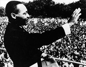 Dr. Martin Luther King, Jr., waving to crowd during from Lincoln Memorial during March on