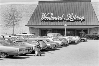 Group of people in parking lot outside Woodward & Lothrop department store, Tysons Corner Mall,