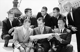 U.S. Vice President Richard Nixon holding model of rocket with Mercury Seven astronauts (left to