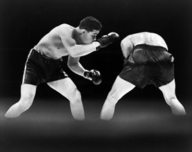 American boxer Joe Louis looking for opening during boxing match with German boxer Max Schmeling,