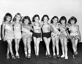 Group of young girls lined up for beauty contest at playground, P.S. 156, Brooklyn, New York City,