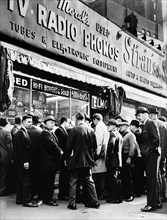 Crowd listening outside radio shop for news on President Kennedy, at Greenwich and Dey Streets, New