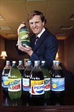 John Sculley, President of PepsiCo, Inc.,  half-length portrait with new 2-liter plastic bottles of