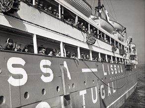 War refugees lining rails of Portuguese ship Nyassa while docked, New York City, New York, USA, New