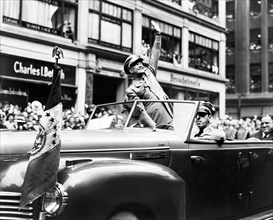 U.S. General Dwight D. Eisenhower waves from automobile during ticker tape parade, New York City,