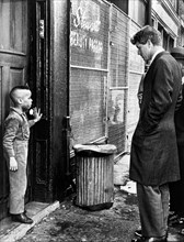 U.S. Senator Robert Kennedy discussing school with young Ricky Taggart of 733 Gates Avenue,