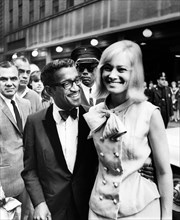 Sammy Davis, Jr., and his wife May Britt attending Broadway premiere of "The Roar of the